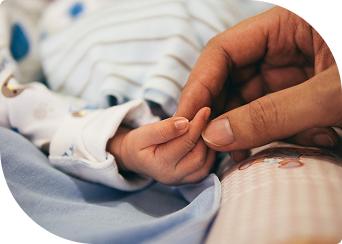 Hand holding baby's hand